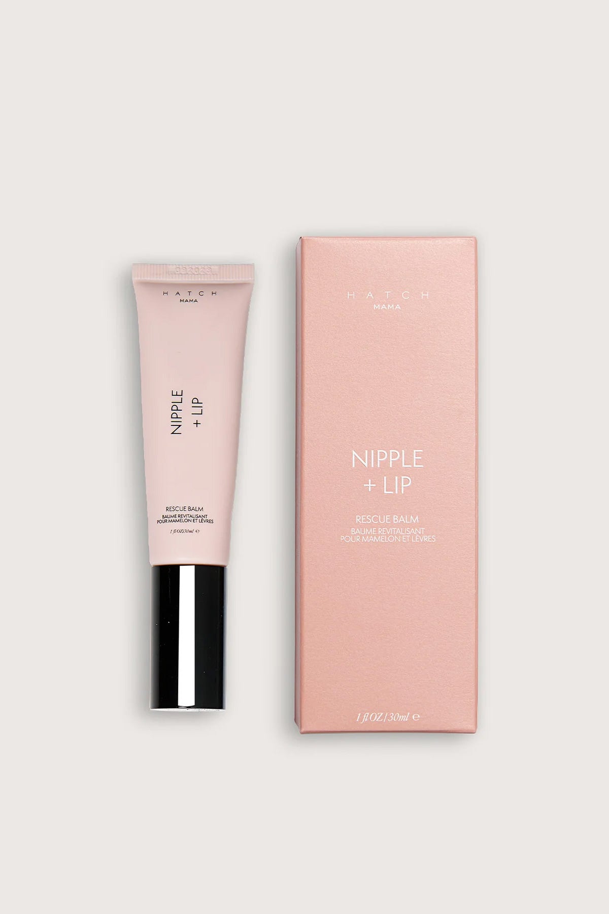 Balsamo premaman per capezzoli e labbra, confezione rosa su sfondo neutro.