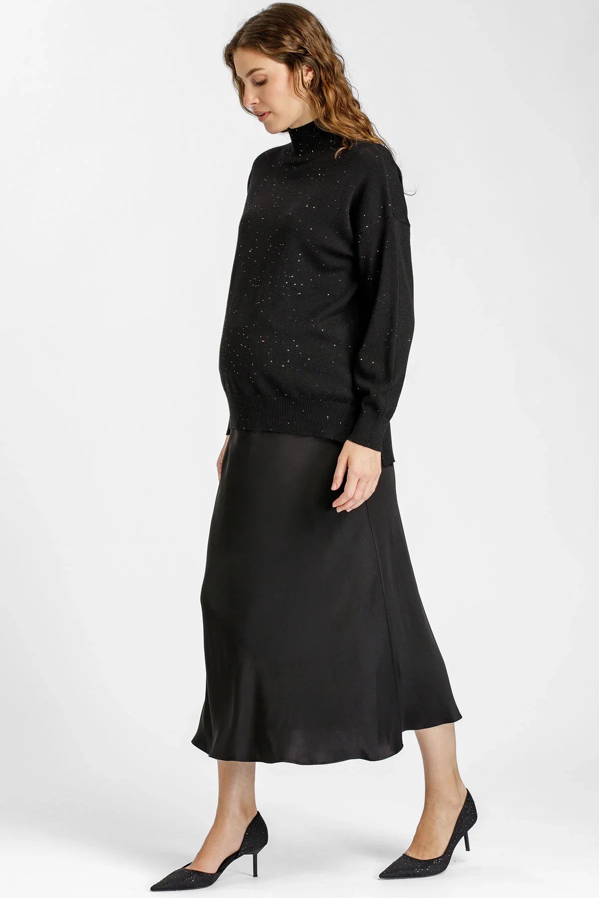 Donna con gonna premaman nera lunga in raso e maglia nera di Pietro Brunelli Maternity