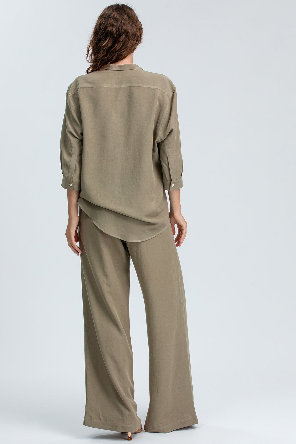 Completo premaman beige con camicia a maniche lunghe e pantaloni larghi, visto da dietro