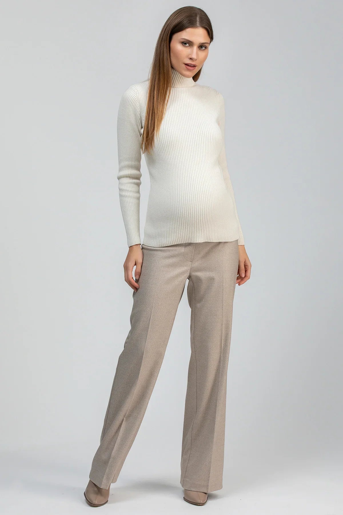 Cream ribbed maternity knit sweater with a fitted silhouette and long sleeves.
